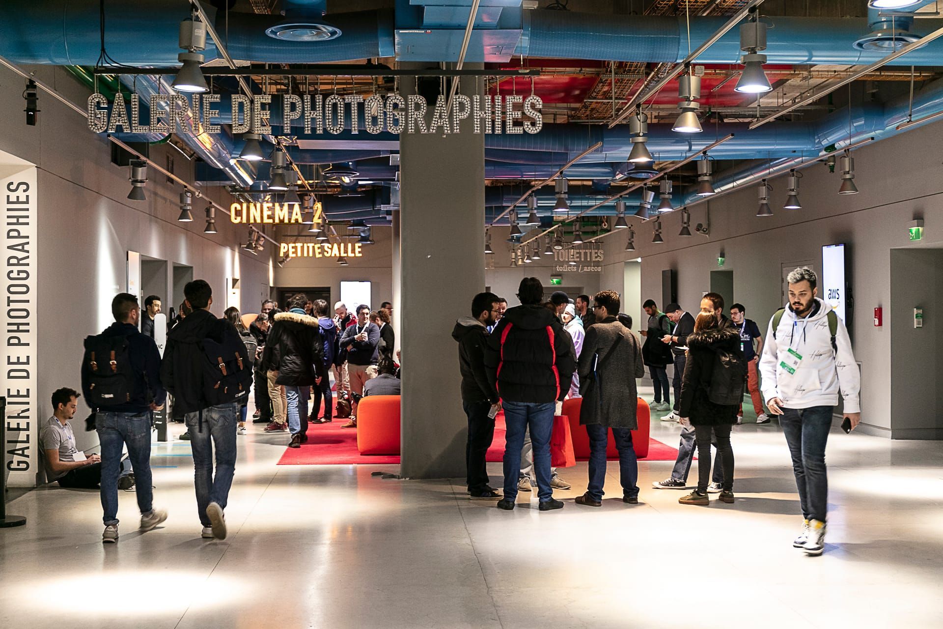 Central aisle lined with community booths in a lively atmosphere